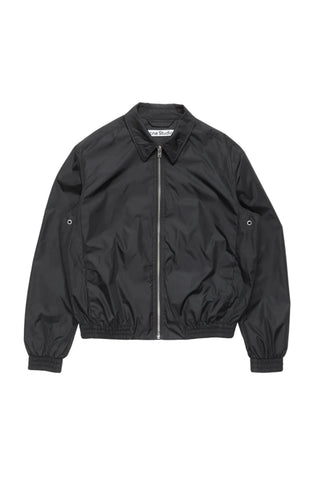 Acne Studios logo-print zip jacket. Features the 1996 logo across the back, recycled nylon with a relaxed fit.  Available at our Lisbon store.