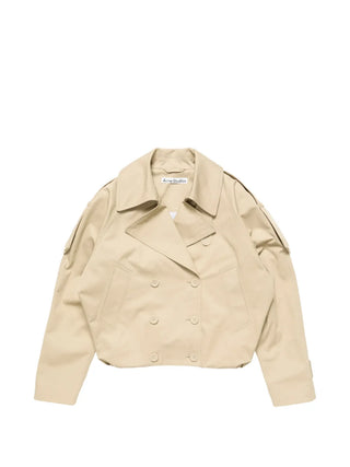 Acne Studios short trench coat in cotton twill. Wide lapels, epaulettes, and a balloon hem for a relaxed, gathered silhouette.  Available at our Lisbon store.