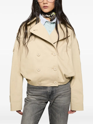 Acne Studios short trench coat in cotton twill. Wide lapels, epaulettes, and a balloon hem for a relaxed, gathered silhouette.  Available at our Lisbon store.