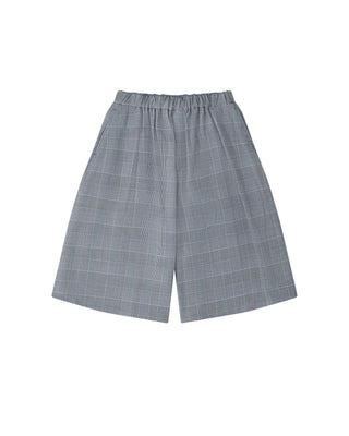 BLACK COMME DES GARÇONS glen check shorts. A tailored knee-length silhouette in a wool blend with a timeless pattern. Available at our Lisbon store. 