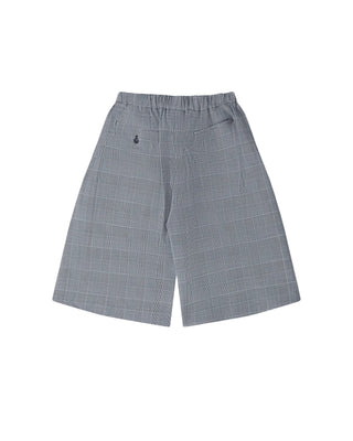 BLACK COMME DES GARÇONS glen check shorts. A tailored knee-length silhouette in a wool blend with a timeless pattern. Available at our Lisbon store. 