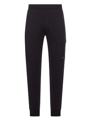 C.P. Company black cotton track trousers with elasticated waistband, lens detail and relaxed fit. A casual staple, available at our Lisbon store.