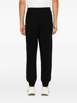 Logo-patch track pants by Canada Goose. 100% cotton with a drawstring waist and elasticated ankles. Available at our Lisbon store. 
