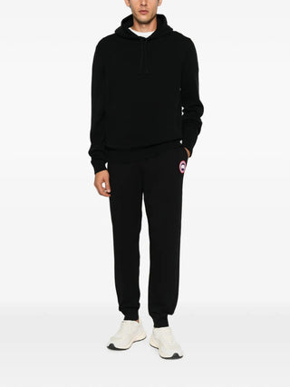Logo-patch track pants by Canada Goose. 100% cotton with a drawstring waist and elasticated ankles. Available at our Lisbon store. 