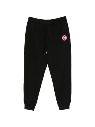 Logo-patch track pants by Canada Goose. 100% cotton with a drawstring waist and elasticated ankles. Available at our Lisbon store. 