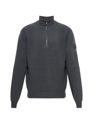 Canada Goose McKinney 1/4 Zip Knit. Crafted from extrafine merino wool with an English rib stitch. Signature tonal Disc patch and sculptural warmth.