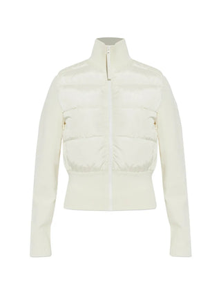 A white puffer jacket from Canada Goose. Clean, contoured quilting with a zip, logo patch and ribbed hem for extra warmth. Available at our Lisbon store. 