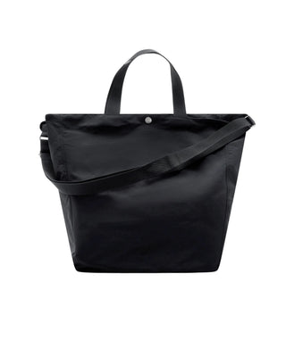 A minimalist nylon shopper from COMME DES GARÇONS HOMME. Features a roomy main compartment and two durable handles. Available at our Lisbon store. 