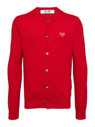 Comme Des Garçons PLAY red cardigan in 100% wool. Features a signature heart patch, ribbed V-neck, and long sleeves for a classic finish. 