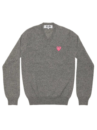 Comme Des Garçons PLAY emblem knit in light grey with a pink heart patch. A V-neck, fine wool sweater with ribbed trims for a refined look.