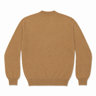 Comme Des Garçons PLAY pink emblem knit in light brown. A signature heart patch V-neck pullover crafted from 100% wool. Available at our Lisbon store.