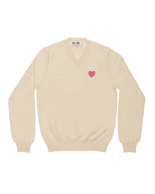 CDG PLAY wool V-neck with signature pink heart emblem. A midweight knit with ribbed cuffs and hem for comfortable everyday wear. Available at our Lisbon store.