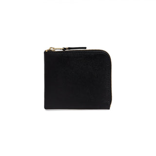 CDG zip-around leather wallet. Smooth leather, gold-tone zipper, and a compact interior with card slots, a bill compartment, and a coin pocket.