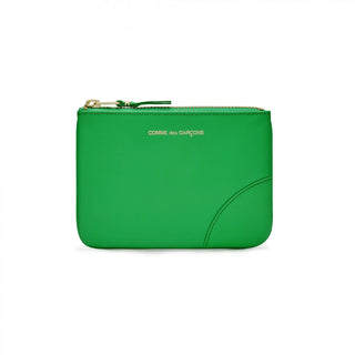 Green leather zip wallet by CDG. Gold-tone logo print, secure zip closure, and an organized interior. Made from premium calfskin, available at our Lisbon store.