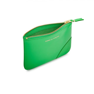 Green leather zip wallet by CDG. Gold-tone logo print, secure zip closure, and an organized interior. Made from premium calfskin, available at our Lisbon store.