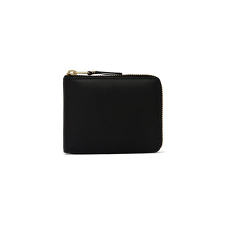 CDG zip-around leather wallet. Smooth calfskin, gold-tone hardware, card slots, and a coin compartment. Available at our Lisbon store. 