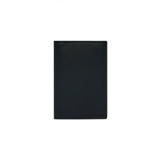 COMME DES GARÇONS bi-fold leather wallet. Classic design in smooth cowhide with card slots and a bill compartment. Gold-tone interior logo.
