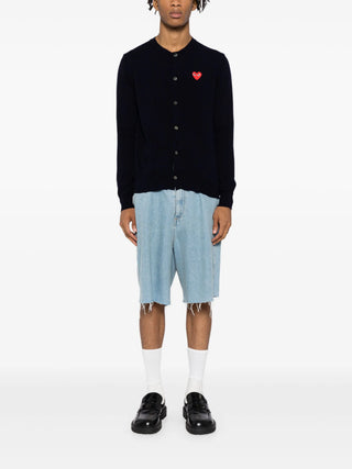 PLAY cardigan by Comme des Garçons featuring iconic heart motif. Pure wool knit in a classic silhouette. Button-front with ribbed trims and signature patch.