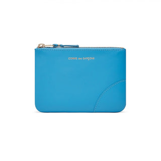 CDG colour-block zip wallet. Crafted from premium leather in a vibrant colour design, features a main compartment, card slots, and a secure top zip fastening.  