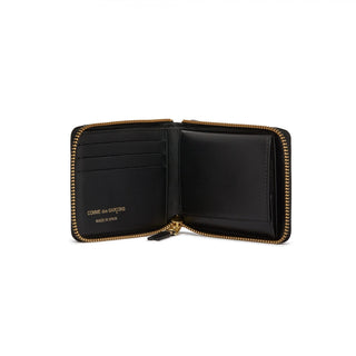 CDG zip-around leather wallet. Smooth calfskin, gold-tone hardware, card slots, and a coin compartment. Available at our Lisbon store. 