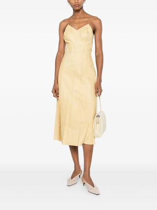 Calvin Klein Collection Fia light yellow leather dress with V-neck and slit, available at our Lisbon store.