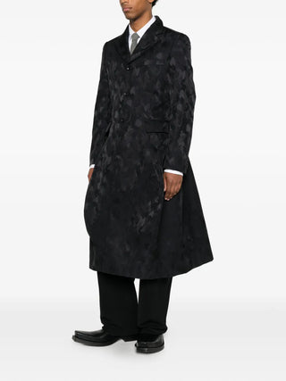 Comme des Garçons Homme Plus black jacquard jacket with draped detail and tailored fit, available at our Lisbon store.