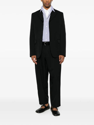 Comme des Garçons Homme Plus black tailored jacket with notched lapels and single-breasted fit, available at our Lisbon store.
