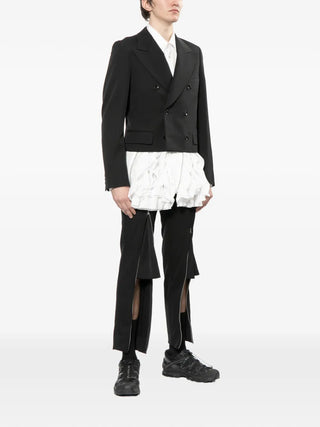 Comme des Garçons Homme Plus black wool double‑breasted blazer with flap pockets. Modern tailored design, available at our Lisbon store.