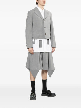 Comme des Garçons Homme Plus stone grey flapped shorts with tailored fit and pockets. Refined casual style, available at our Lisbon stor