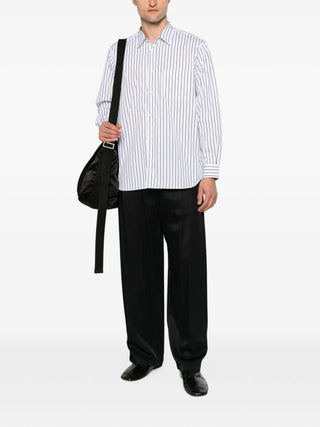 Comme des Garçons Shirt blue striped shirt with classic collar and chest pocket. A refined everyday piece, available at our Lisbon store.