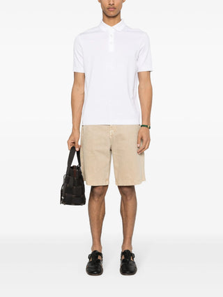 HERNO white knitted cotton polo shirt with ribbed trim and button placket. A refined essential, available at our Lisbon store.