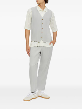HOMME PLISSÉ ISSEY MIYAKE pleated shirt. Signature vertical pleats, classic collar, and front button fastening. 100% polyester. Available at our Lisbon store. 