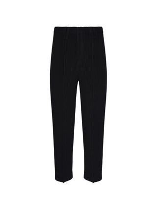 Homme Plissé Issey Miyake black pleated trousers with elasticated waist. Lightweight and refined. Available at our Lisbon store.