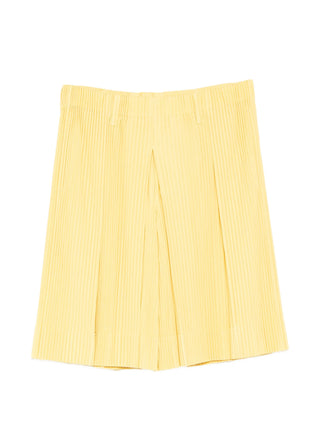 Homme Plissé Issey Miyake pleated trousers in button yellow with elasticated waist. Modern tailored fit, available at our Lisbon store.