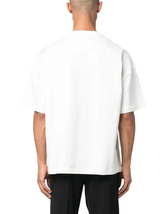 Person wearing a plain white t-shirt with black pants