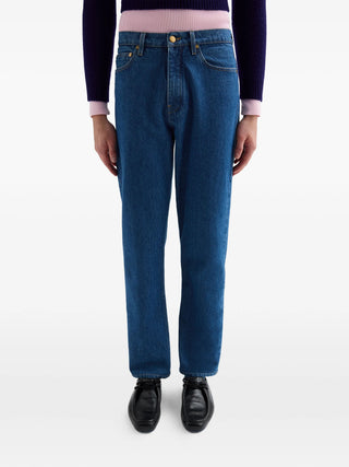  Jil Sander blue logo-patch jeans with tapered leg, five pockets and zip fly. Clean everyday denim, available at our Lisbon store.