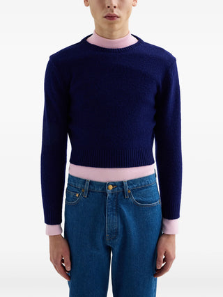 Jil Sander dark blue cropped wool sweater with crew neck and back button detail. Modern fit, available at our Lisbon store.