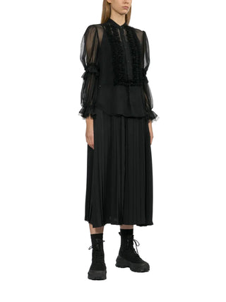 Junya Watanabe black pleated midi skirt with clean rear fastening and structured silhouette — available at our Lisbon store.