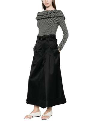 Junya Watanabe black pleated wide-leg trousers with belt and cuffed hem — available at our Lisbon store.