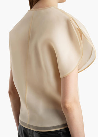 KHAITE Briar top. Silk organza, sculptural sleeves, and a notched V-neck. Made in Italy. A modern statement piece, available at our Lisbon store. 