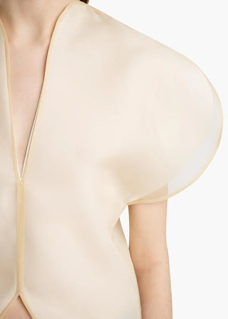 KHAITE Briar top. Silk organza, sculptural sleeves, and a notched V-neck. Made in Italy. A modern statement piece, available at our Lisbon store. 
