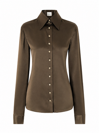 KHAITE Ivy long-sleeve shirt. Elegant high collar, buttoned front, and clean lines. A refined staple, available at our Lisbon store. 