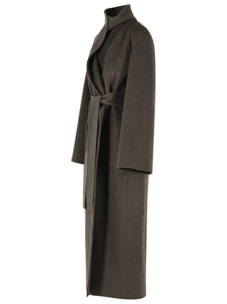 KHAITE Romare coat. A sculptural longline wrap silhouette in double-face wool. Detachable belt, side pockets. Made in Italy, available at our Lisbon store. 