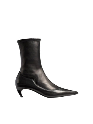 KHAITE's Valerie Mid-Calf Boots: sleek lines, sculpted heel. A refined silhouette that anchors every look with downtown polish. Available at our Lisbon store. 