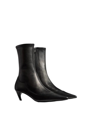 KHAITE's Valerie Mid-Calf Boots: sleek lines, sculpted heel. A refined silhouette that anchors every look with downtown polish. Available at our Lisbon store. 