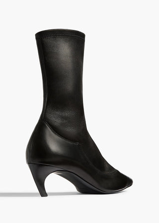 KHAITE's Valerie Mid-Calf Boots: sleek lines, sculpted heel. A refined silhouette that anchors every look with downtown polish. Available at our Lisbon store. 