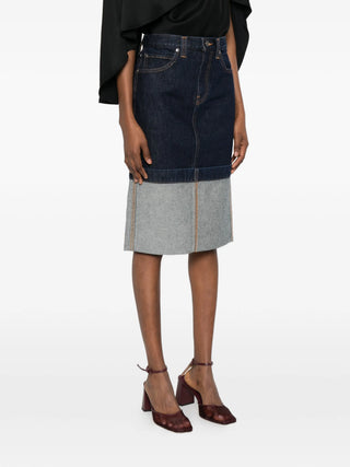 Khaite denim skirt with Black top and sandals.