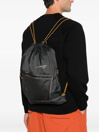 Klättermusen black Algir Sack backpack with drawstring closure and zip pocket. Lightweight and practical, available at our Lisbon store.
