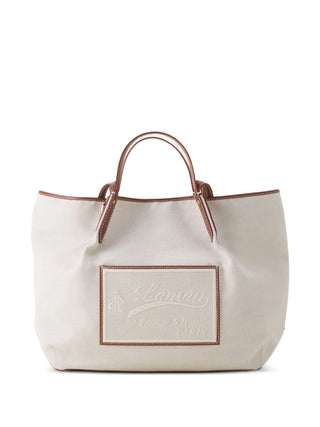 White tote bag with brown handles and a logo by Lanvin
