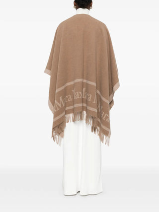 Logo-print fringed poncho by MAX MARA. 100% wool with logo lettering and fringe detailing. A versatile layering piece for any occasion, available at our Lisbon store. 